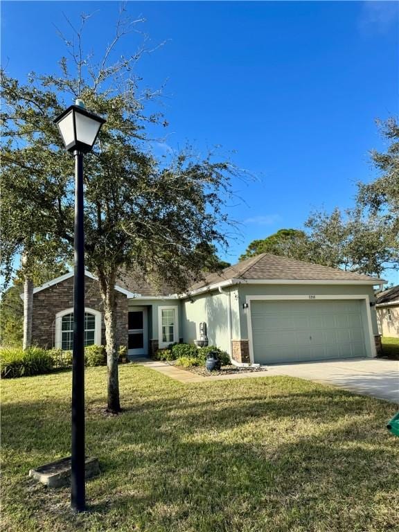 view of front of home featuring a garage and a front lawn