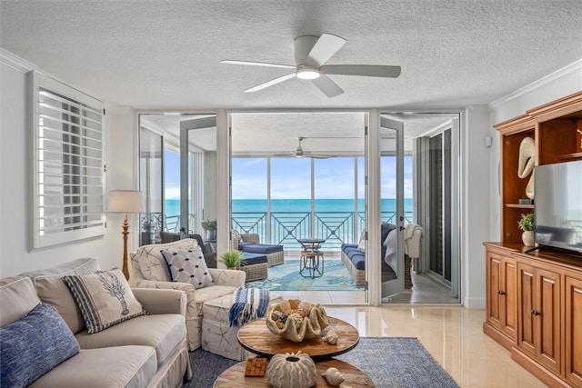 living room featuring a textured ceiling, a wall of windows, crown molding, and ceiling fan