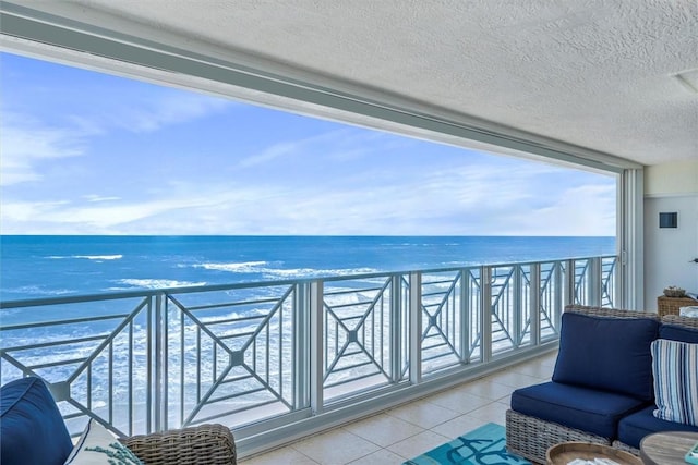 balcony with a beach view and a water view