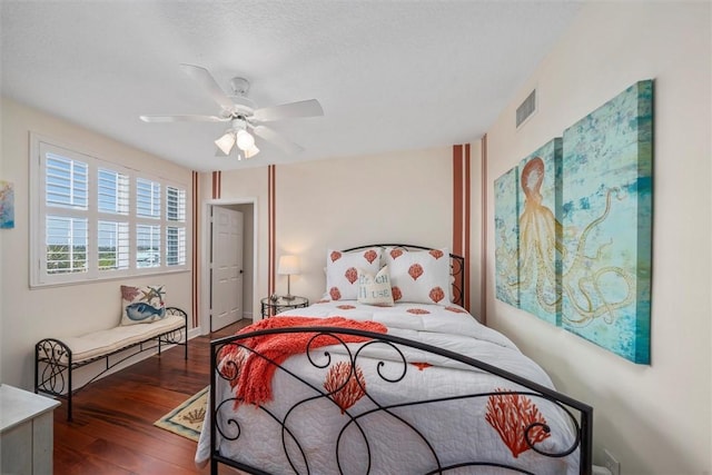 bedroom with ceiling fan and dark wood-type flooring