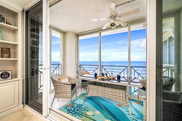 interior space featuring a water view and ceiling fan