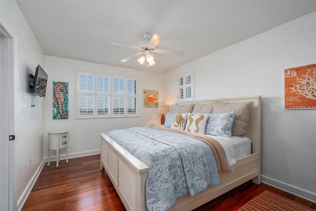 bedroom with ceiling fan and dark hardwood / wood-style floors