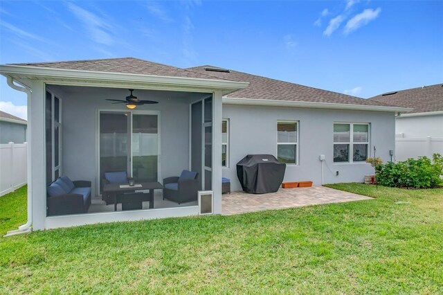 rear view of house featuring a yard, fence, and a sunroom