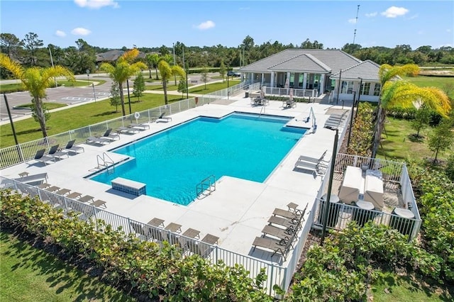 community pool featuring a patio area and fence