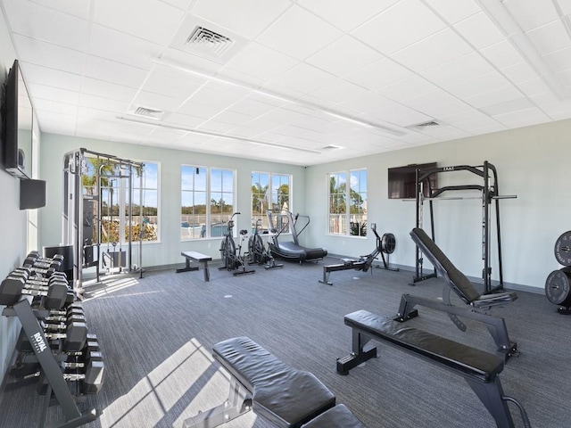 gym with baseboards, visible vents, and carpet flooring