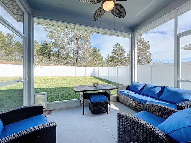 sunroom with a healthy amount of sunlight and ceiling fan