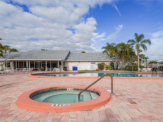 view of swimming pool featuring a community hot tub