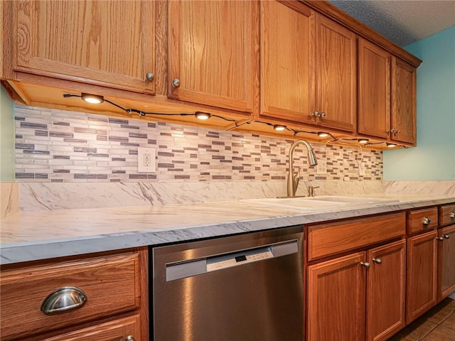 kitchen featuring sink, decorative backsplash, and stainless steel dishwasher