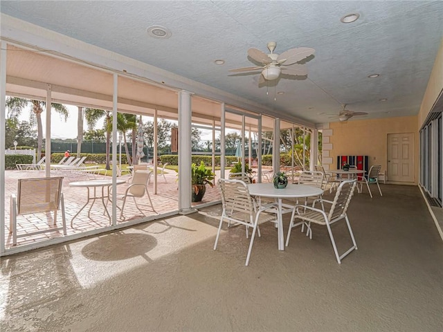 sunroom featuring ceiling fan