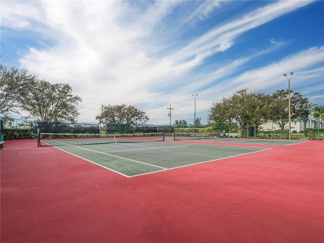 view of tennis court with basketball hoop