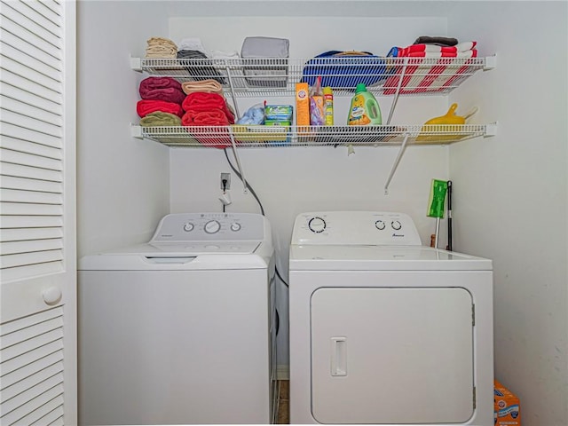 clothes washing area with washer and dryer