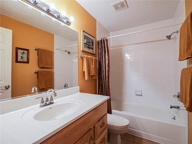 full bathroom with tile patterned flooring, vanity, toilet, a textured ceiling, and shower / bath combo with shower curtain