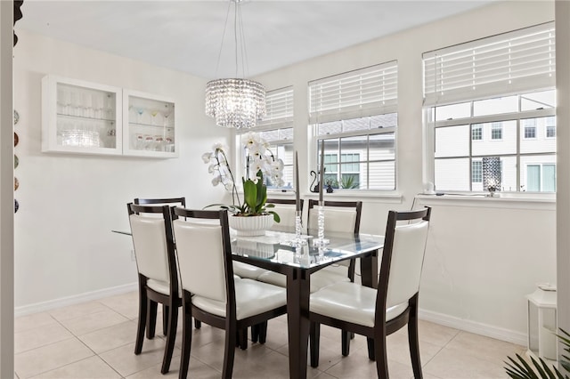 dining space featuring a notable chandelier and light tile patterned floors