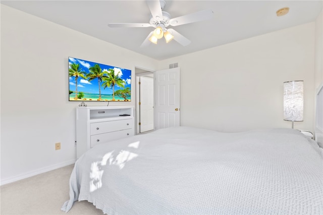 bedroom featuring light carpet and ceiling fan