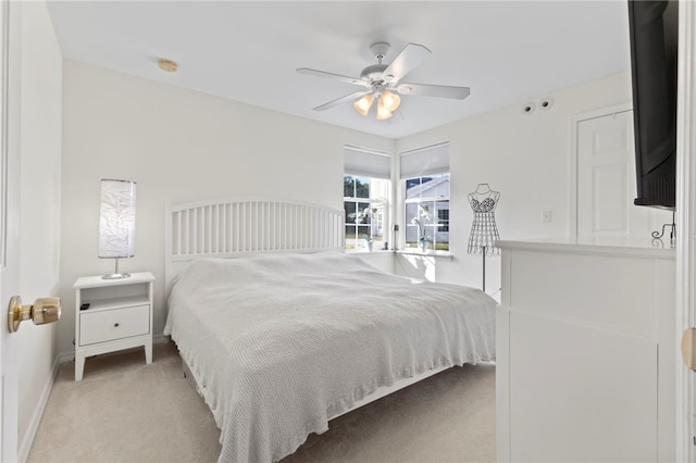 bedroom with light carpet and ceiling fan