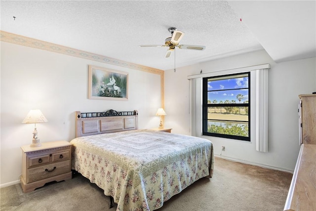 bedroom featuring carpet floors, a textured ceiling, ceiling fan, and baseboards