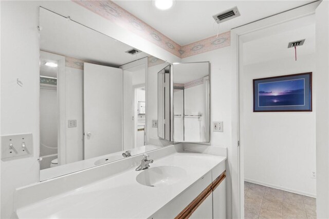 3 Plantation Dr Unit 202, Vero Beach, FL 32966 - bathroom featuring toilet, baseboards, visible vents, and vanity