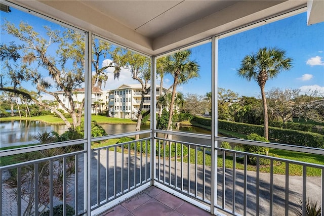 unfurnished sunroom featuring a water view