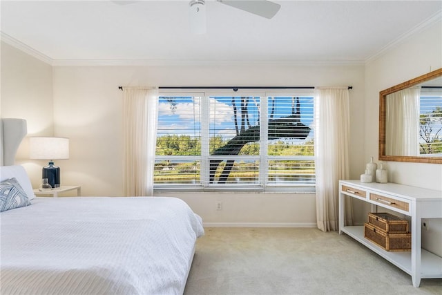 bedroom with ceiling fan, ornamental molding, baseboards, and light colored carpet