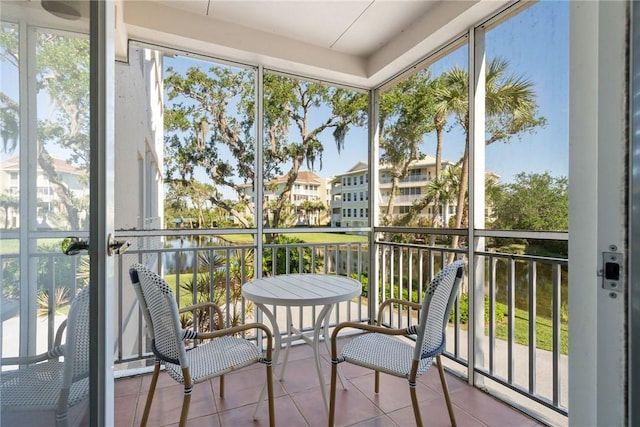 sunroom with a water view and a healthy amount of sunlight