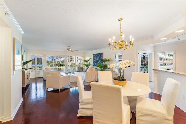 dining room with dark wood-style flooring, crown molding, and baseboards