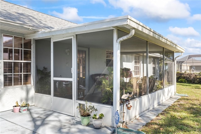 view of side of home featuring a sunroom