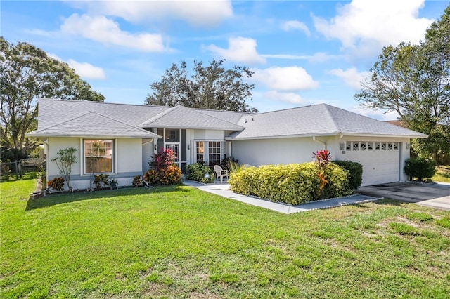 single story home with a garage and a front lawn