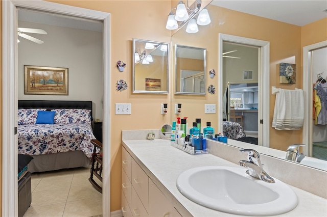 bathroom with tile patterned flooring, vanity, and ceiling fan