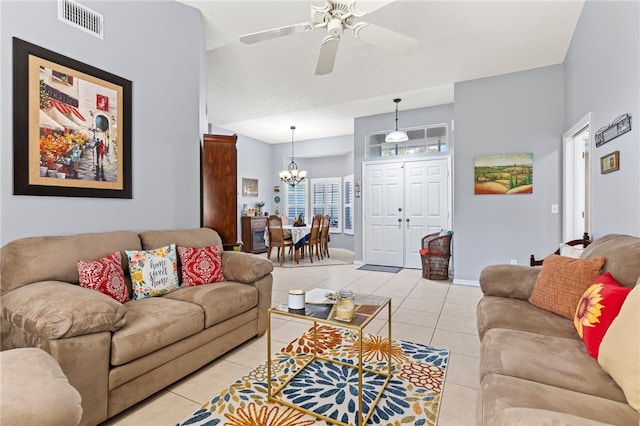 living room with light tile patterned floors and ceiling fan with notable chandelier