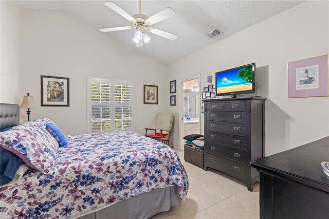 tiled bedroom with connected bathroom, high vaulted ceiling, a textured ceiling, and ceiling fan