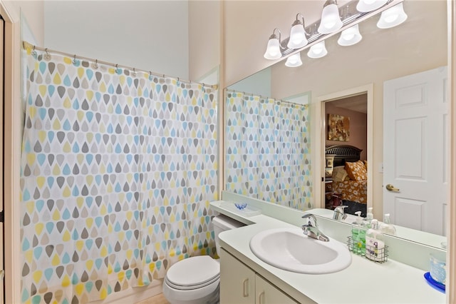 bathroom featuring tile walls, vanity, and toilet