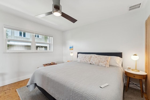 bedroom with ceiling fan and light parquet flooring