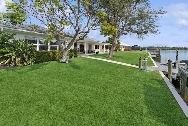 view of yard featuring a water view and a boat dock