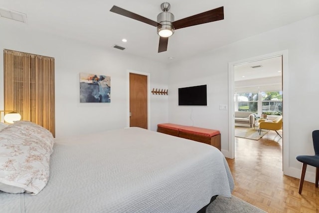 bedroom with ceiling fan and light parquet flooring