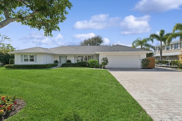 view of front of home with a garage and a front yard