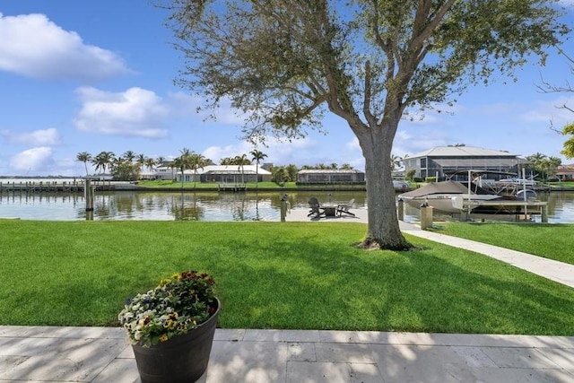 view of yard featuring a water view and a dock