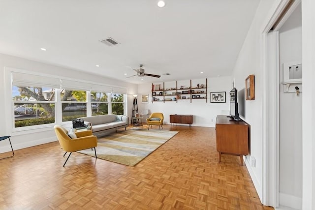 living room featuring ceiling fan and light parquet floors