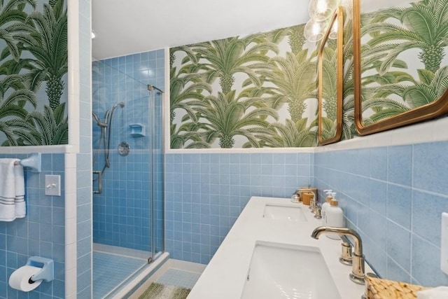 bathroom featuring vanity, tile walls, and walk in shower