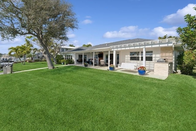 back of property featuring a patio and a yard