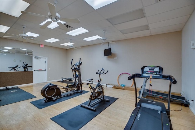 exercise area featuring ceiling fan, wood finished floors, and visible vents