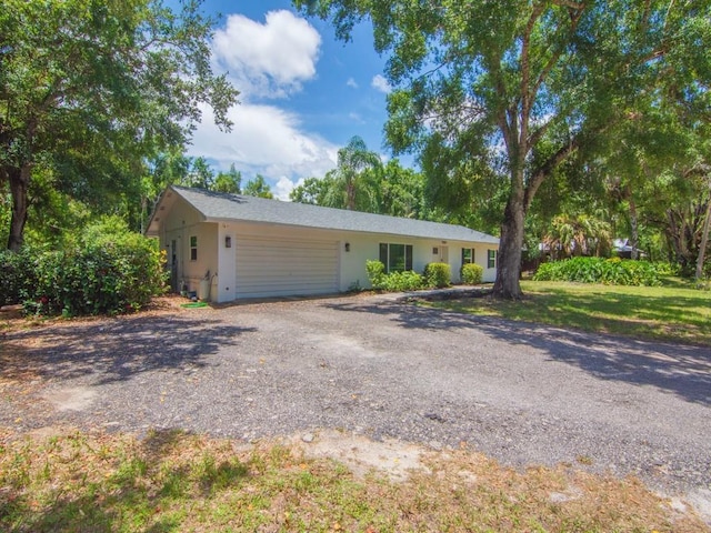 6345 7th Ln, Vero Beach, FL 32968 - ranch-style house with driveway, stucco siding, and a garage