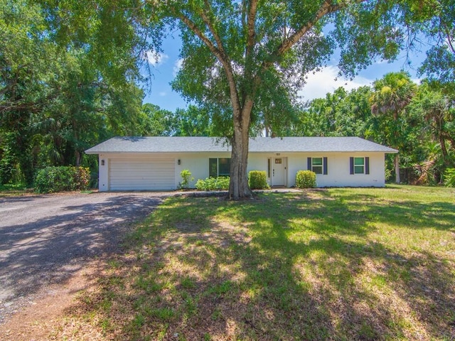 6345 7th Ln, Vero Beach, FL 32968 - ranch-style house featuring driveway, a garage, stucco siding, and a front lawn