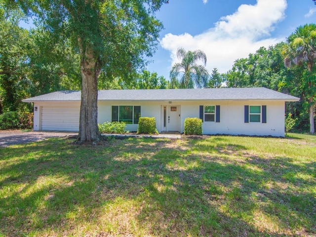 6345 7th Ln, Vero Beach, FL 32968 - single story home featuring stucco siding, an attached garage, a front yard, and driveway