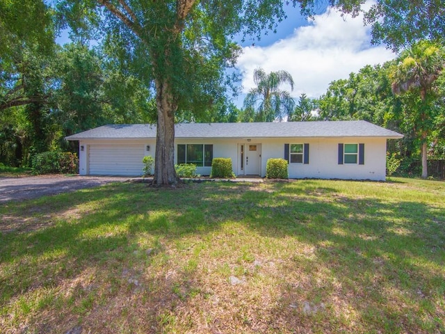 6345 7th Ln, Vero Beach, FL 32968 - single story home featuring an attached garage, driveway, a front yard, and stucco siding