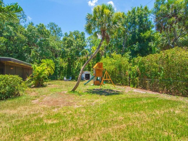6345 7th Ln, Vero Beach, FL 32968 - fenced backyard with a playground