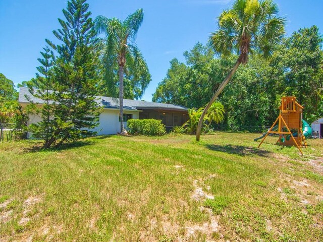 6345 7th Ln, Vero Beach, FL 32968 - view of grassy yard with a playground