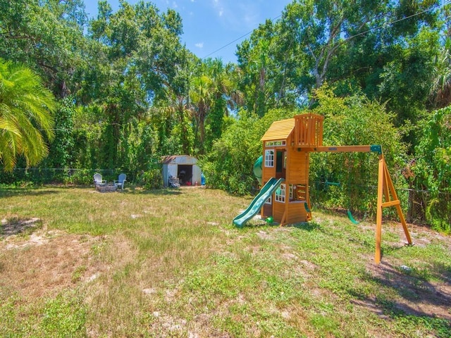 6345 7th Ln, Vero Beach, FL 32968 - fenced backyard with a playground and a storage unit