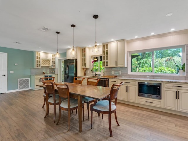 6345 7th Ln, Vero Beach, FL 32968 - dining area with light wood-style floors and recessed lighting