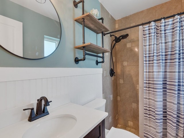 6345 7th Ln, Vero Beach, FL 32968 - bathroom featuring tiled shower, a wainscoted wall, and vanity