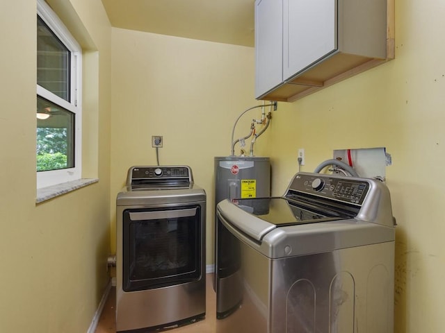 6345 7th Ln, Vero Beach, FL 32968 - laundry area featuring cabinet space, washing machine and clothes dryer, and water heater